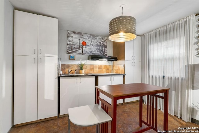 kitchen featuring white cabinetry, sink, and decorative backsplash