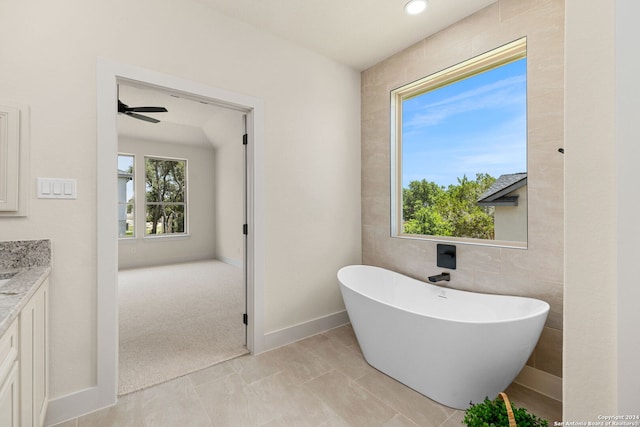 bathroom featuring tile patterned floors, vanity, and a bathing tub