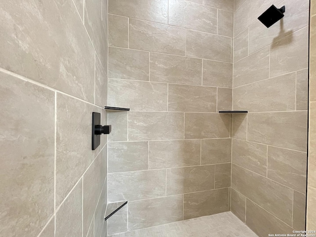 bathroom with a tile shower