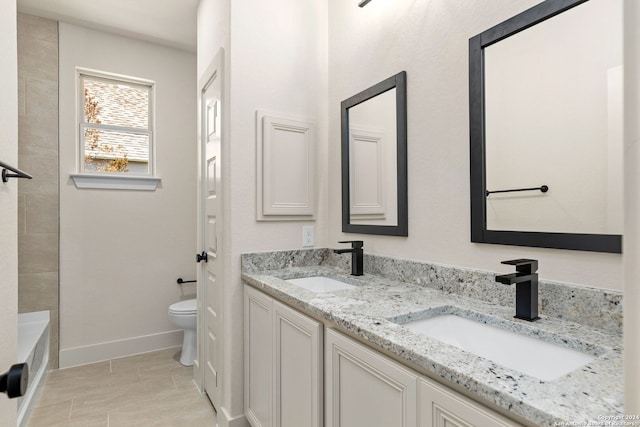 bathroom with tile patterned floors, vanity, and toilet