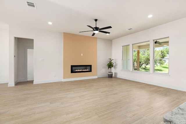 unfurnished living room featuring ceiling fan