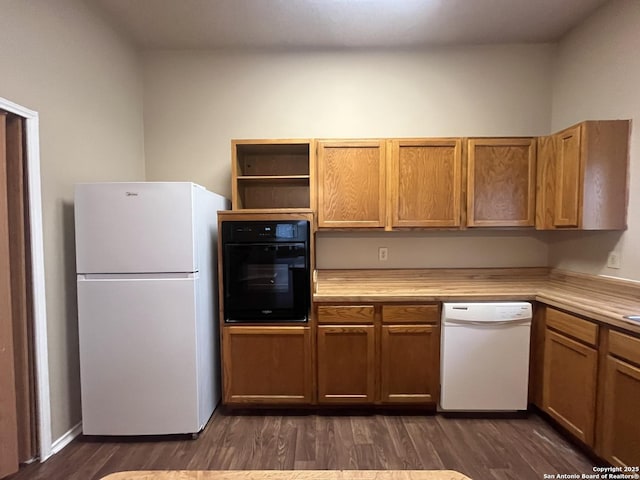 kitchen with dark wood-type flooring and white appliances