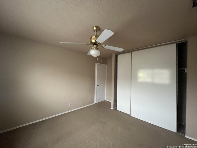 unfurnished bedroom featuring ceiling fan, carpet floors, a closet, and a textured ceiling