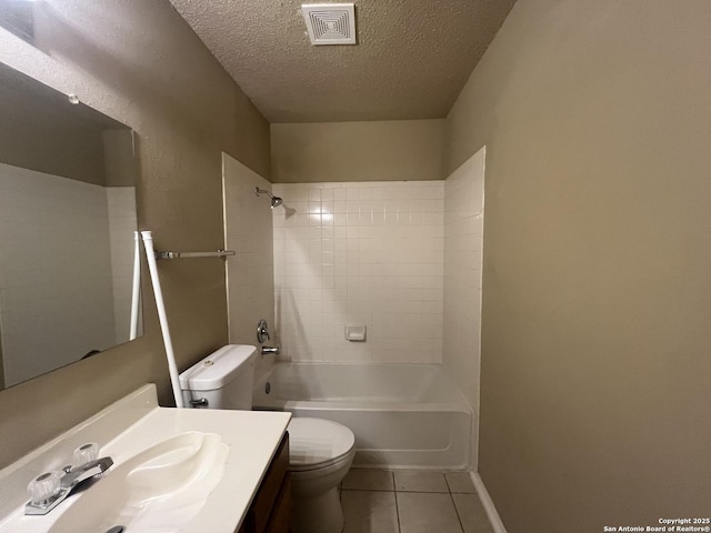 full bathroom featuring tile patterned flooring, vanity, a textured ceiling, toilet, and tiled shower / bath