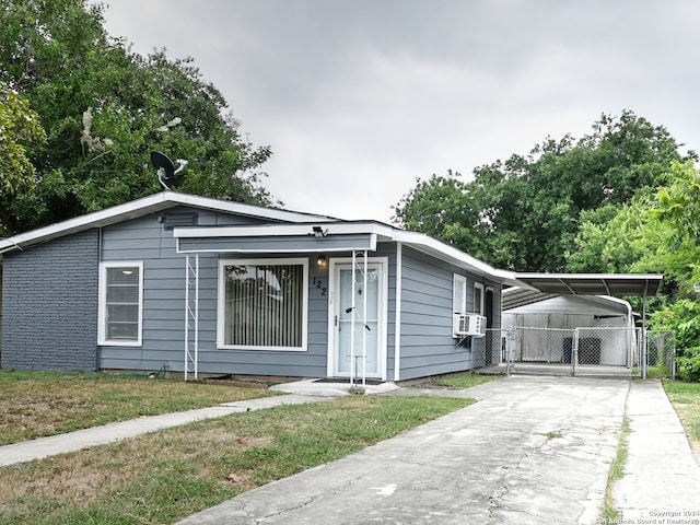 view of front facade featuring a carport and cooling unit