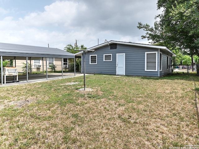 rear view of property with a lawn