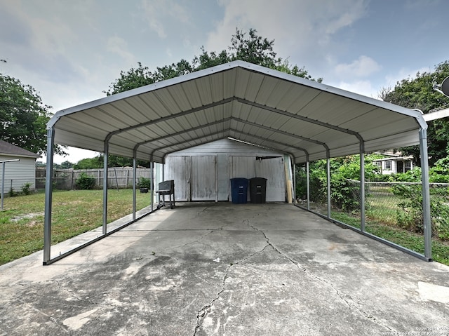 view of vehicle parking with a lawn and a carport