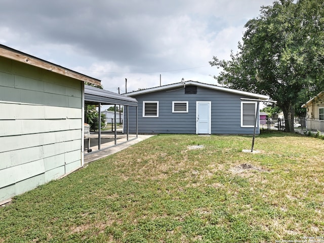 rear view of property featuring a yard