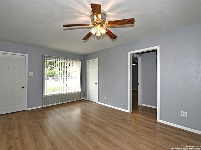 unfurnished room with hardwood / wood-style floors, a textured ceiling, and ceiling fan