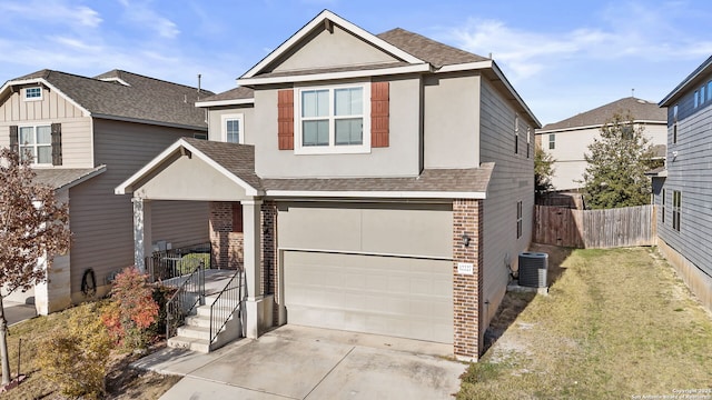 front facade featuring cooling unit, a garage, and a front lawn