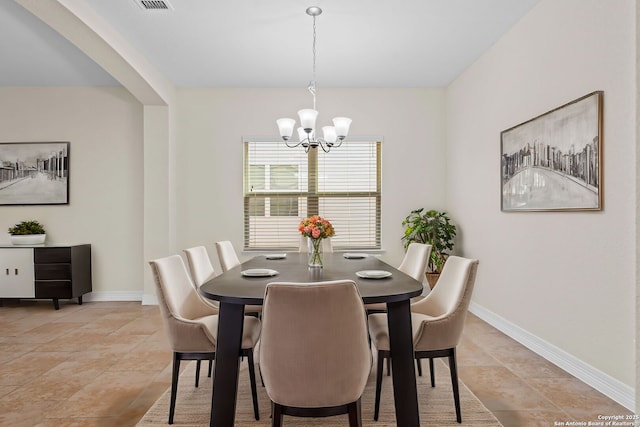 dining room featuring light tile patterned flooring and a chandelier