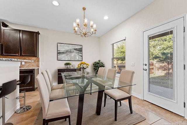 tiled dining space featuring a chandelier