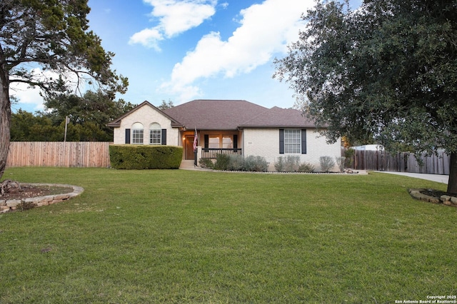 ranch-style home featuring a front yard and a porch