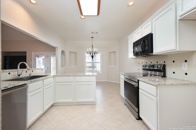 kitchen featuring sink, white cabinetry, stainless steel appliances, light stone countertops, and light tile patterned flooring