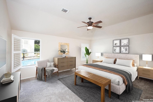 carpeted bedroom with vaulted ceiling and ceiling fan