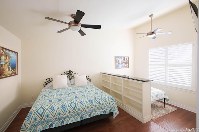 bedroom featuring vaulted ceiling, dark hardwood / wood-style flooring, and ceiling fan