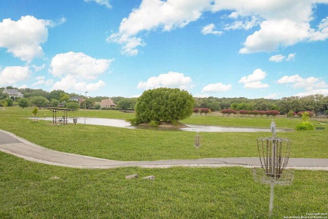 view of community with a water view and a lawn