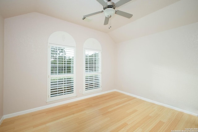 unfurnished room featuring ceiling fan, wood-type flooring, and vaulted ceiling