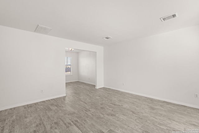 spare room with light wood-type flooring