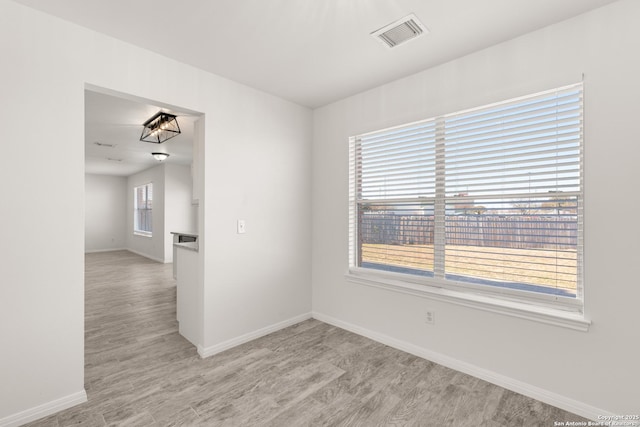 unfurnished room with light hardwood / wood-style floors