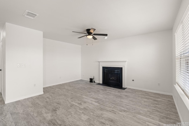 unfurnished living room featuring light wood-type flooring and ceiling fan