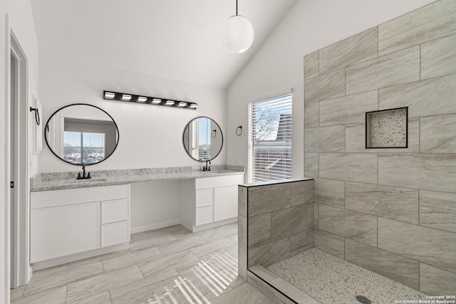 bathroom with vaulted ceiling and vanity