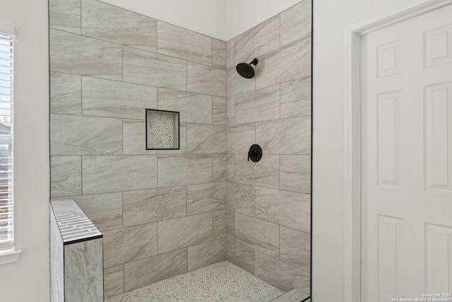 bathroom with a tile shower