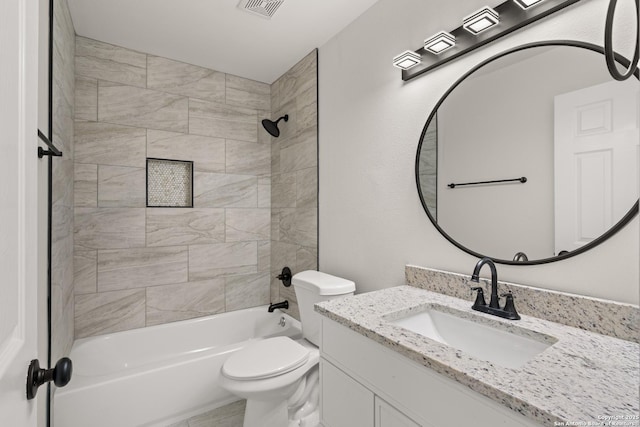 full bathroom with tiled shower / bath combo, vanity, and toilet