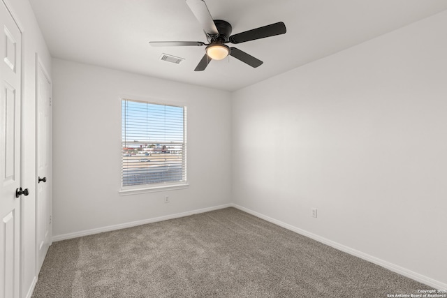 carpeted spare room featuring ceiling fan