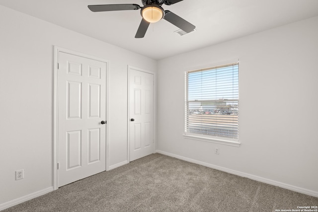 unfurnished bedroom featuring light carpet and ceiling fan