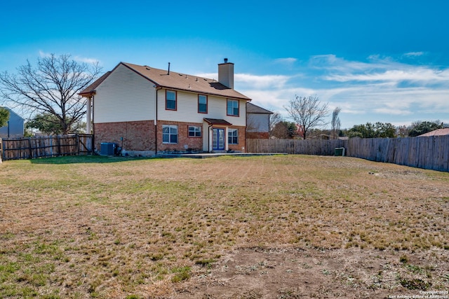 back of property featuring cooling unit and a lawn