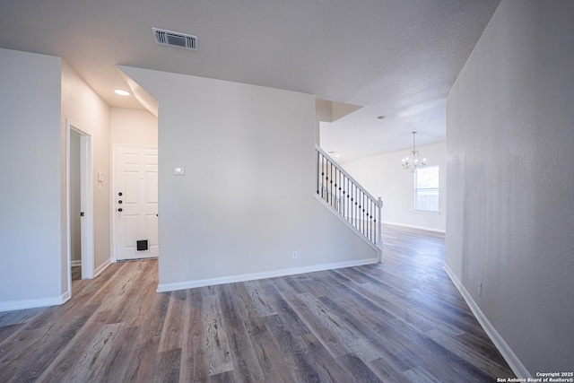 interior space with dark hardwood / wood-style floors and an inviting chandelier