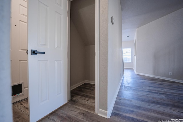 corridor featuring dark hardwood / wood-style floors and a textured ceiling