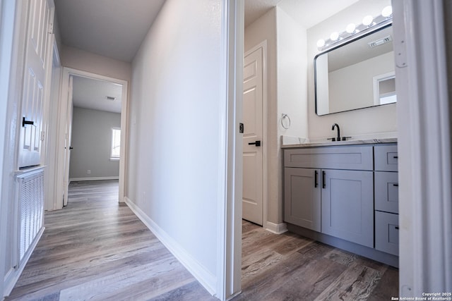 bathroom with vanity and hardwood / wood-style floors