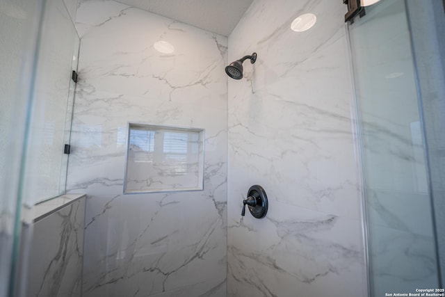 bathroom with a tile shower