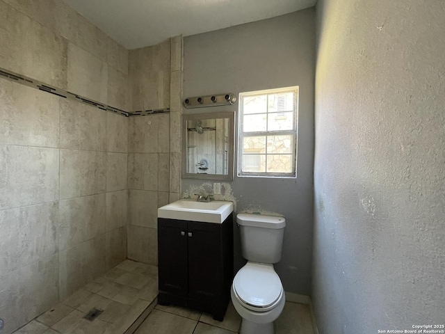 bathroom with vanity, tile patterned flooring, and toilet