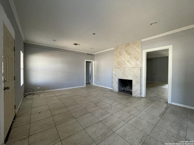 unfurnished living room featuring a tiled fireplace and ornamental molding