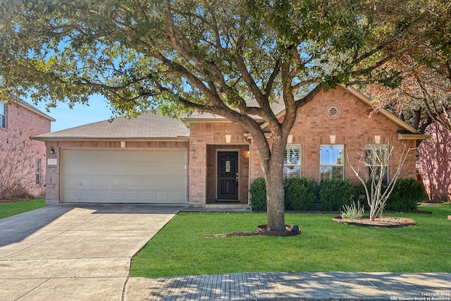 view of front of property with a garage and a front lawn