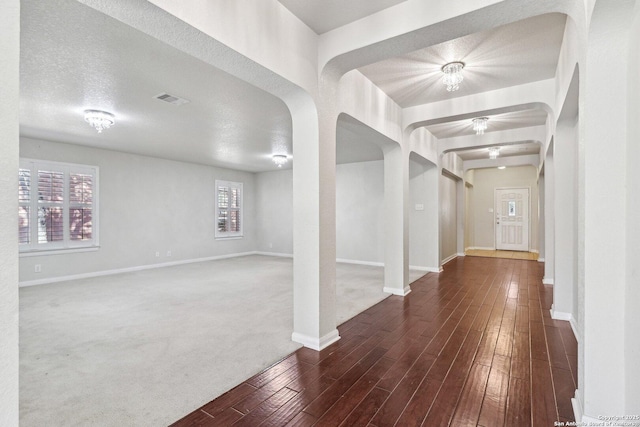 foyer entrance featuring dark hardwood / wood-style flooring and a textured ceiling