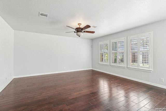 unfurnished room featuring a textured ceiling, dark hardwood / wood-style floors, and ceiling fan