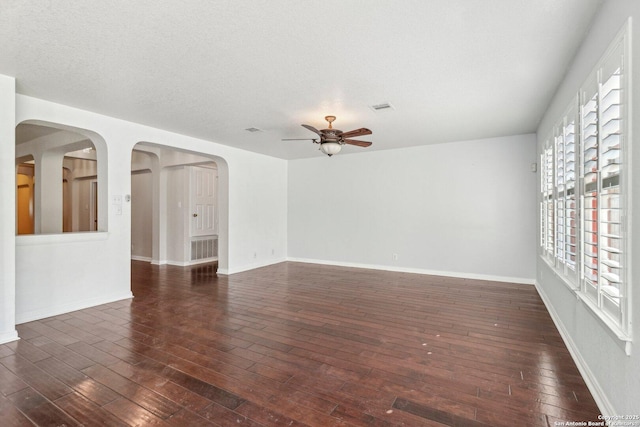 unfurnished room featuring dark hardwood / wood-style floors, a textured ceiling, and ceiling fan