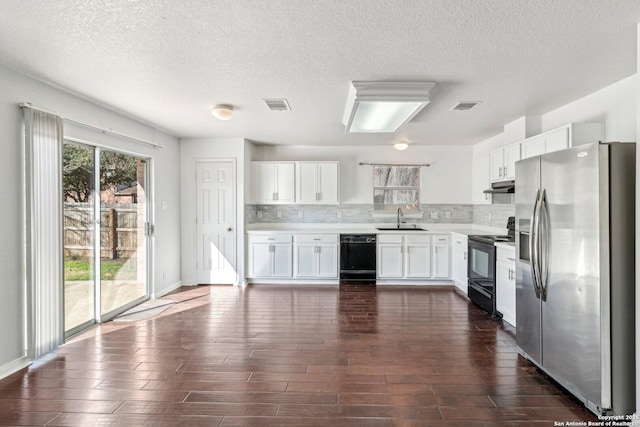 kitchen featuring sink, backsplash, dark hardwood / wood-style floors, black appliances, and white cabinets