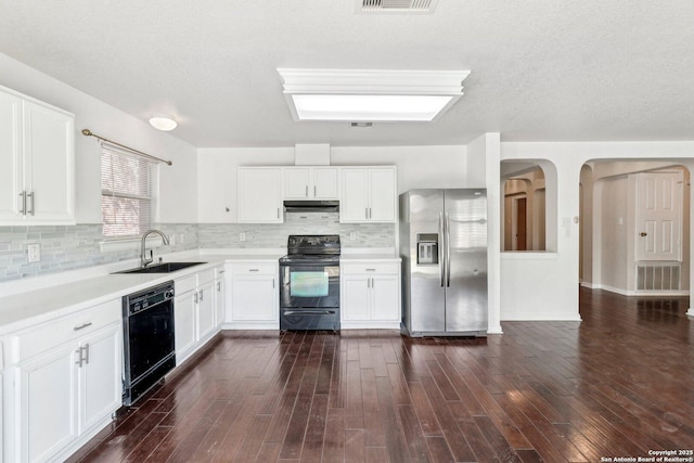 kitchen featuring white cabinetry, sink, dark hardwood / wood-style floors, and black appliances