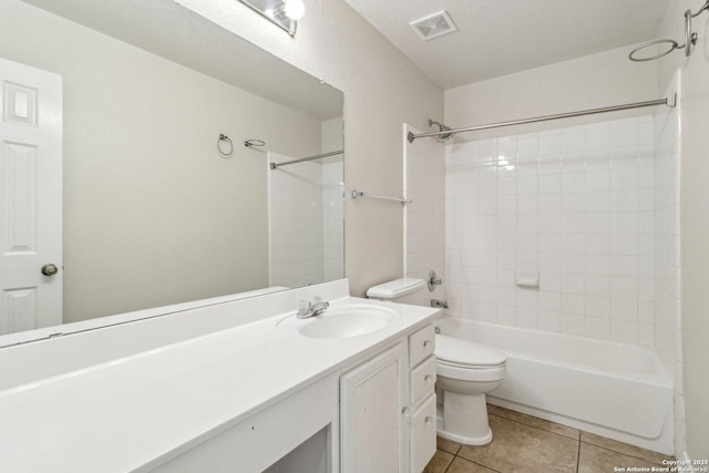 full bathroom featuring tile patterned floors, toilet, tiled shower / bath combo, and vanity