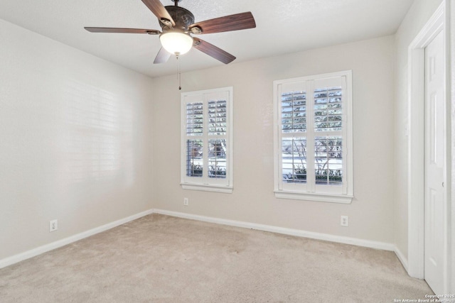 spare room with light carpet and ceiling fan