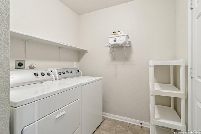 clothes washing area with light tile patterned floors and independent washer and dryer