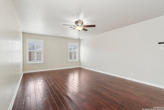 unfurnished room featuring a textured ceiling, dark wood-type flooring, and ceiling fan