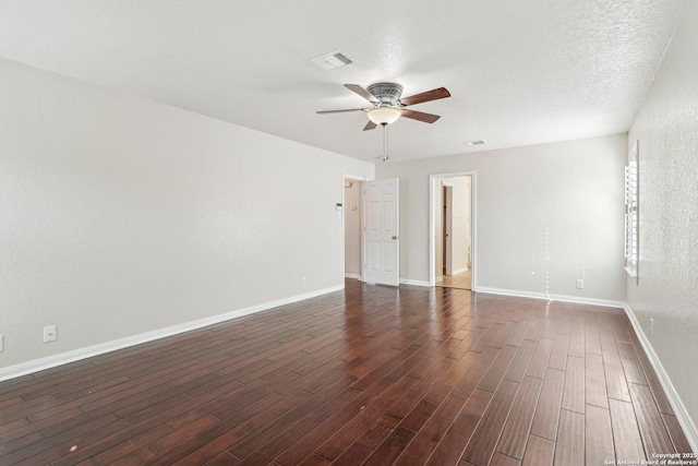 spare room with ceiling fan, dark hardwood / wood-style flooring, and a textured ceiling