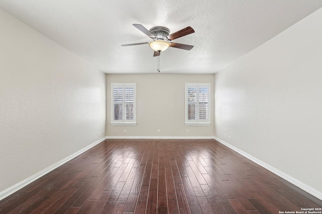 spare room with ceiling fan, dark wood-type flooring, and a textured ceiling