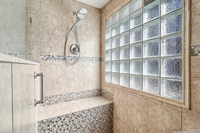 bathroom with a tile shower